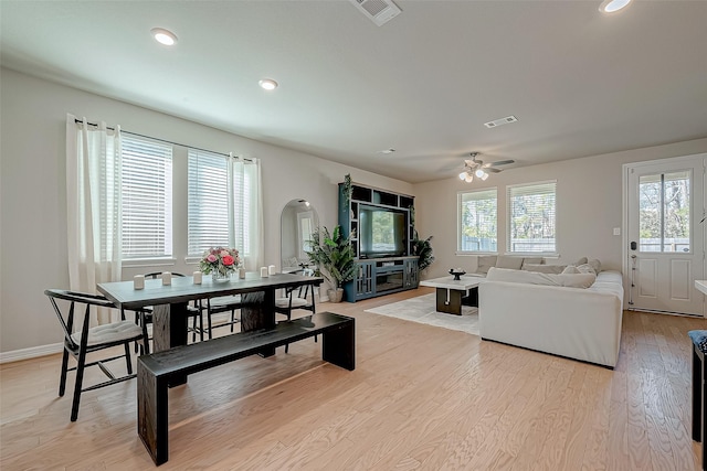 dining room with recessed lighting, visible vents, arched walkways, and light wood finished floors