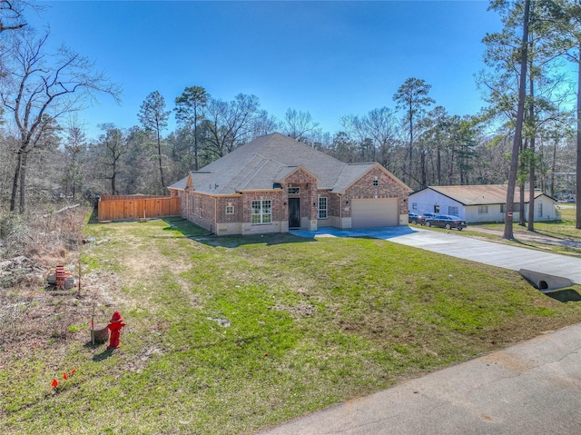 view of front of home with a front lawn, driveway, fence, an attached garage, and brick siding