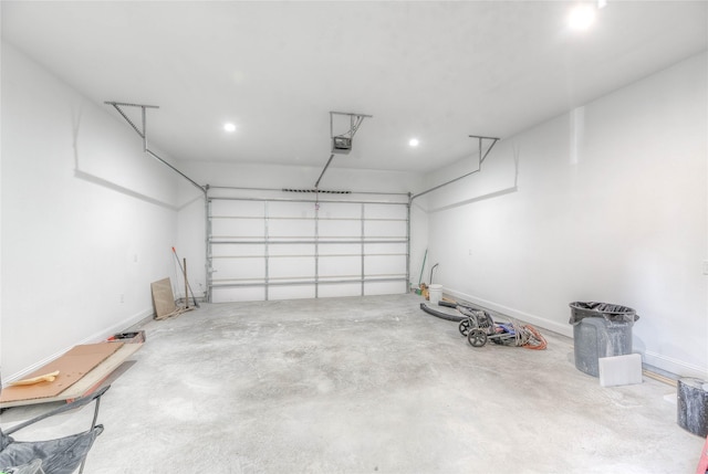 garage featuring a garage door opener and baseboards