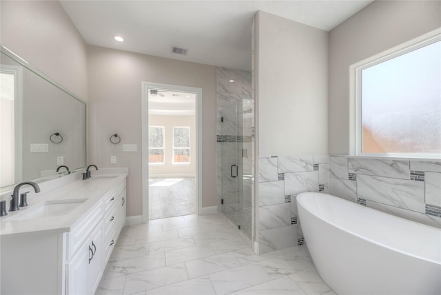 bathroom featuring a shower stall, visible vents, marble finish floor, and a sink