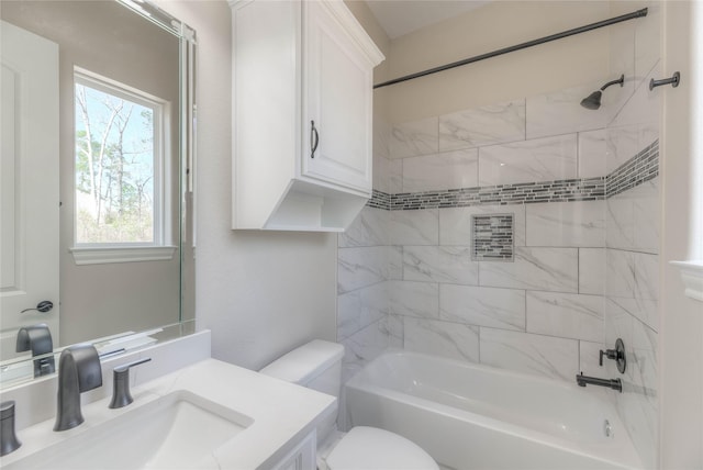 bathroom featuring toilet, vanity, and shower / tub combination