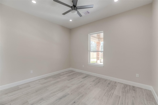 unfurnished room featuring light wood-type flooring, visible vents, baseboards, and ceiling fan