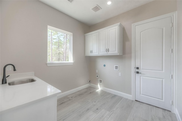 clothes washing area with visible vents, washer hookup, a sink, cabinet space, and hookup for an electric dryer