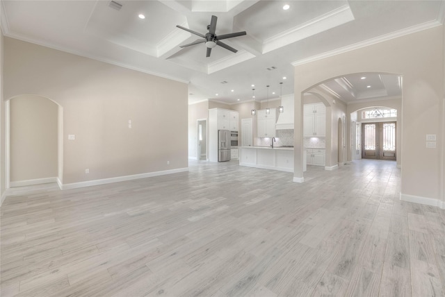 unfurnished living room with light wood-style flooring, coffered ceiling, french doors, arched walkways, and ceiling fan