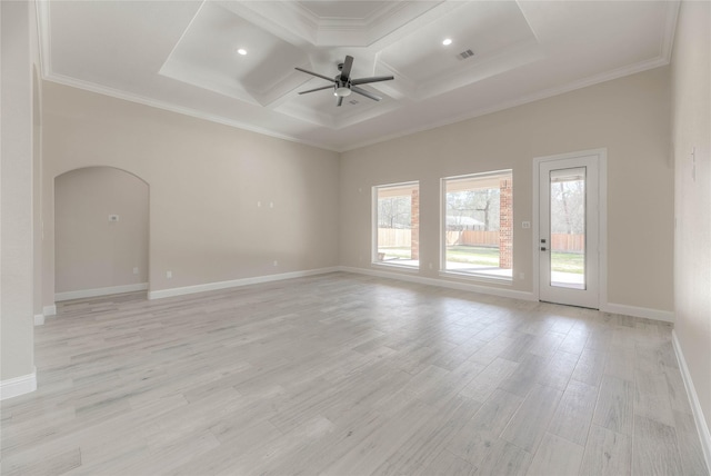 spare room featuring a ceiling fan, visible vents, coffered ceiling, light wood-style flooring, and arched walkways