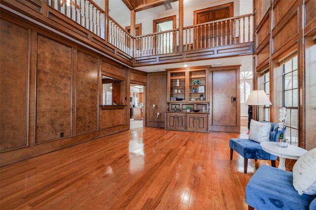 unfurnished living room featuring a high ceiling and light wood-style flooring