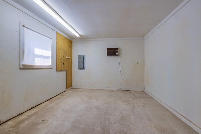 spare room with electric panel, concrete floors, and a wall mounted air conditioner