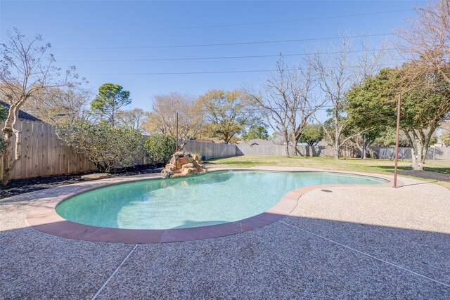 view of pool with a fenced in pool, a patio, a lawn, and a fenced backyard