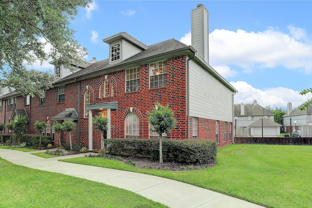 1373 El Camino Village Dr, Houston, TX 77058 - view of front of property with brick siding, a chimney, and a front lawn
