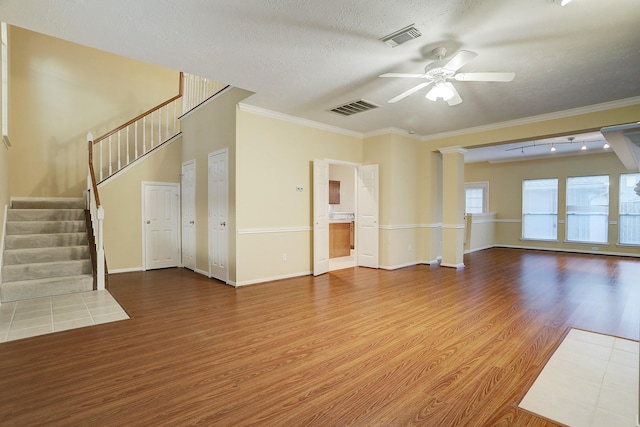 1373 El Camino Village Dr, Houston, TX 77058 - unfurnished living room with a ceiling fan, stairway, wood finished floors, and visible vents