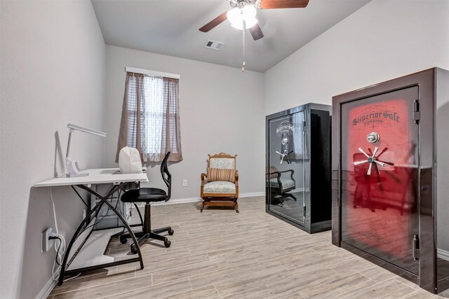 office space with a ceiling fan, light wood-style floors, visible vents, and baseboards