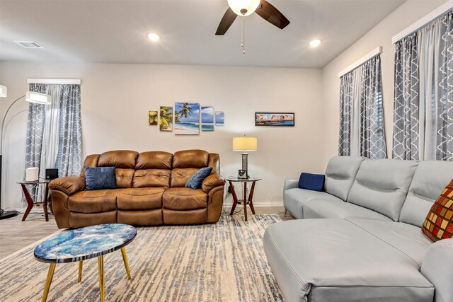 living area with visible vents, baseboards, recessed lighting, wood finished floors, and a ceiling fan