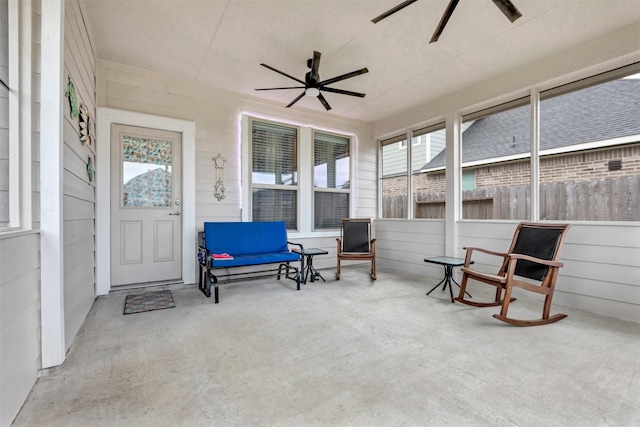 sunroom / solarium featuring ceiling fan