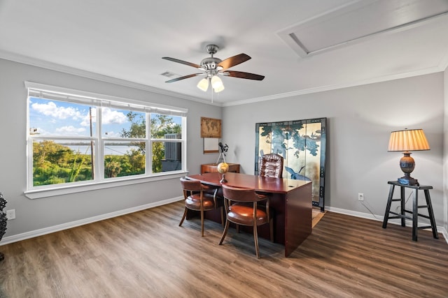 home office featuring visible vents, ceiling fan, baseboards, ornamental molding, and wood finished floors