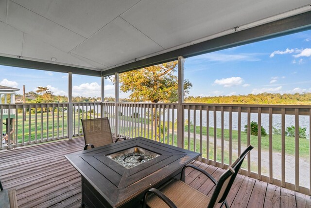 deck featuring a water view and an outdoor fire pit