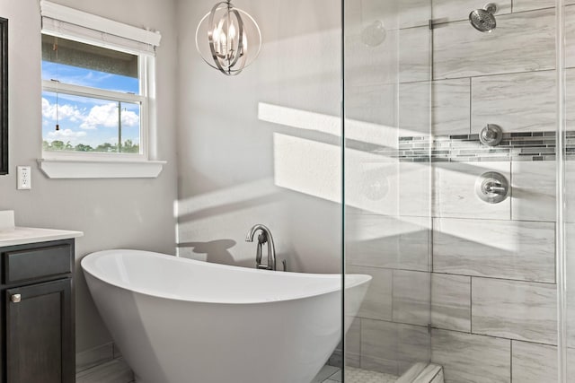 bathroom with a freestanding tub, vanity, and a shower stall