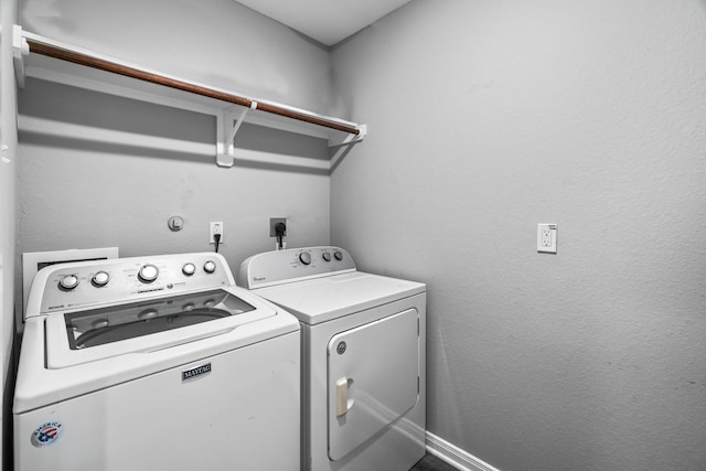 laundry room with washing machine and clothes dryer and laundry area