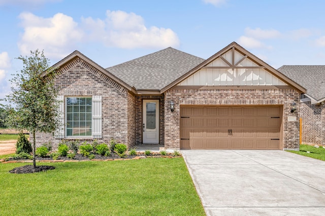 view of front of property with brick siding, an attached garage, a front lawn, and roof with shingles