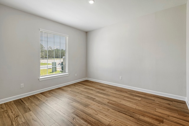 unfurnished room featuring wood finished floors and baseboards