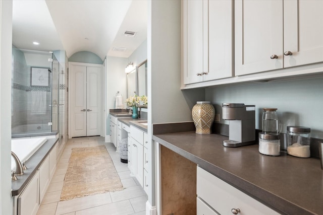 full bath with tile patterned flooring, visible vents, a garden tub, a stall shower, and vanity