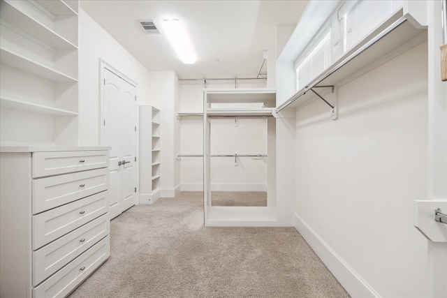 spacious closet with visible vents and carpet floors