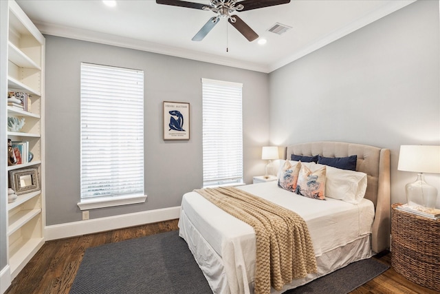 bedroom with visible vents, multiple windows, and wood finished floors