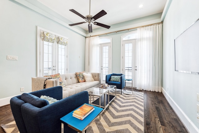 living room featuring baseboards, plenty of natural light, dark wood finished floors, and a ceiling fan