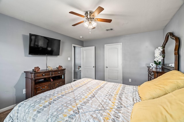 bedroom with visible vents, baseboards, carpet flooring, a closet, and a ceiling fan