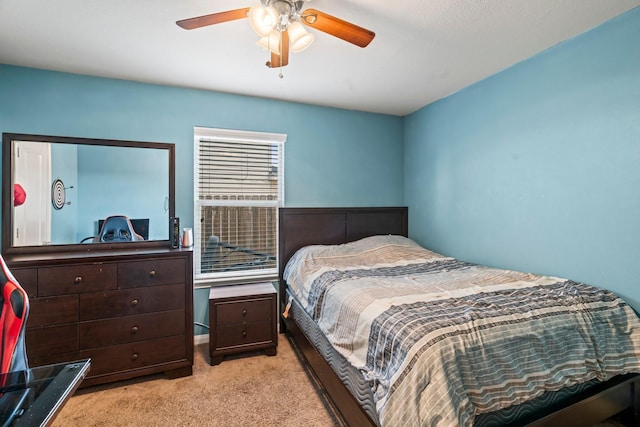 bedroom with light carpet and a ceiling fan