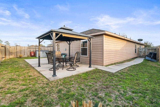 rear view of property with a gazebo, a yard, a patio, and a fenced backyard