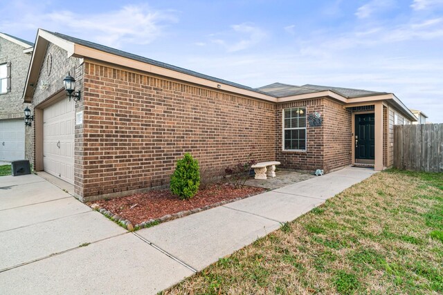 view of front of home featuring concrete driveway, a garage, and brick siding