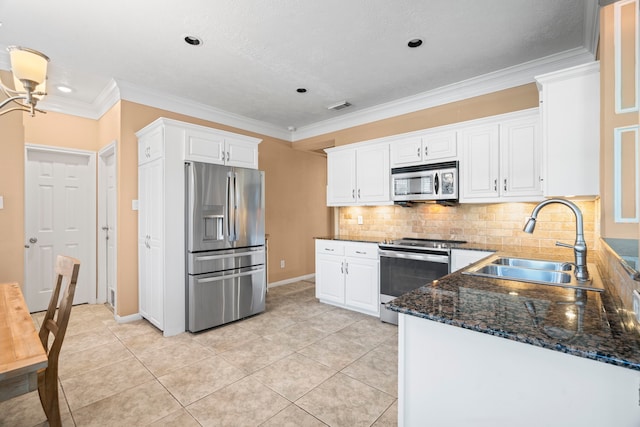 kitchen featuring visible vents, a sink, stainless steel appliances, white cabinetry, and crown molding