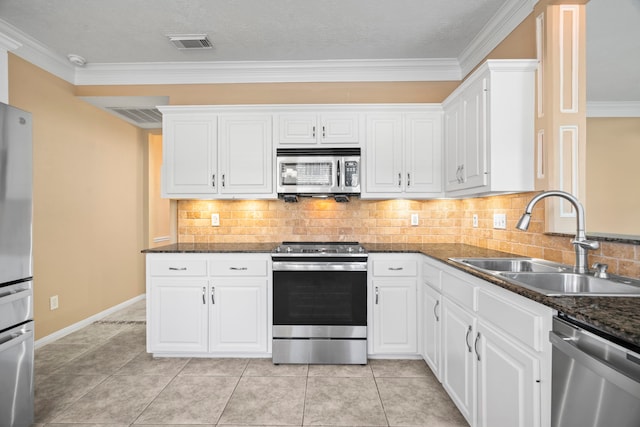 kitchen featuring a sink, stainless steel appliances, visible vents, and white cabinets