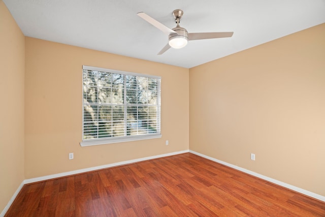 unfurnished room featuring ceiling fan, baseboards, and wood finished floors