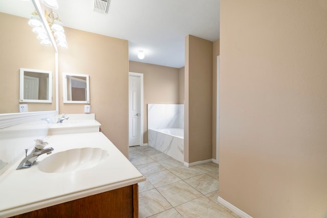 bathroom featuring tile patterned floors, visible vents, a sink, double vanity, and a bath