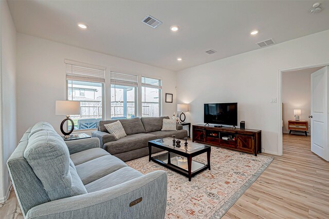 living room featuring recessed lighting, visible vents, and light wood-style floors