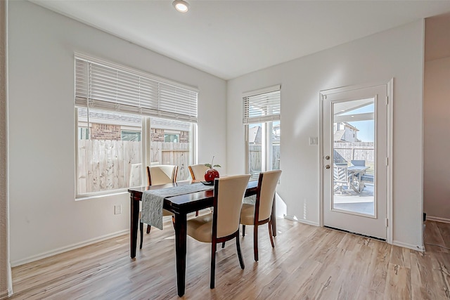 dining room featuring baseboards and light wood finished floors