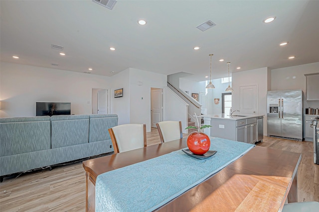 dining room with visible vents, recessed lighting, and light wood-style floors