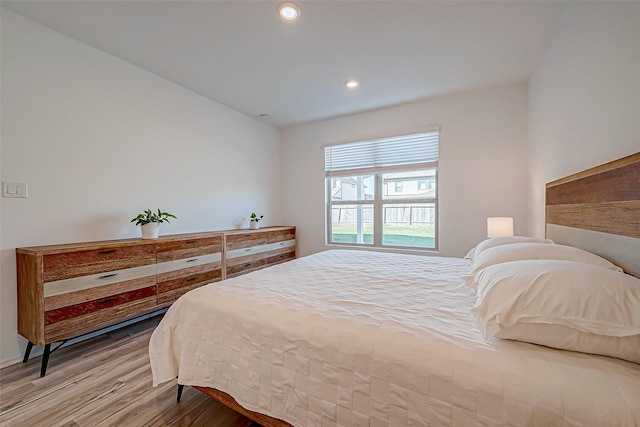 bedroom with recessed lighting and wood finished floors