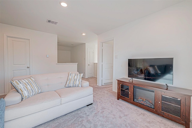 living room with recessed lighting, visible vents, and carpet