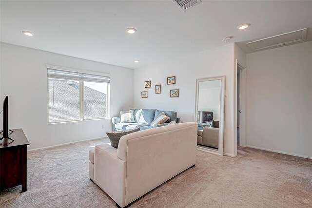 living area featuring recessed lighting, visible vents, light carpet, and baseboards