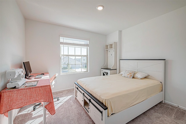 bedroom featuring light carpet and baseboards