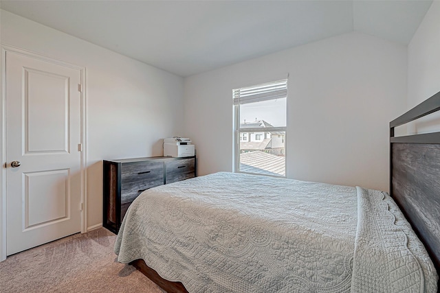 carpeted bedroom with lofted ceiling