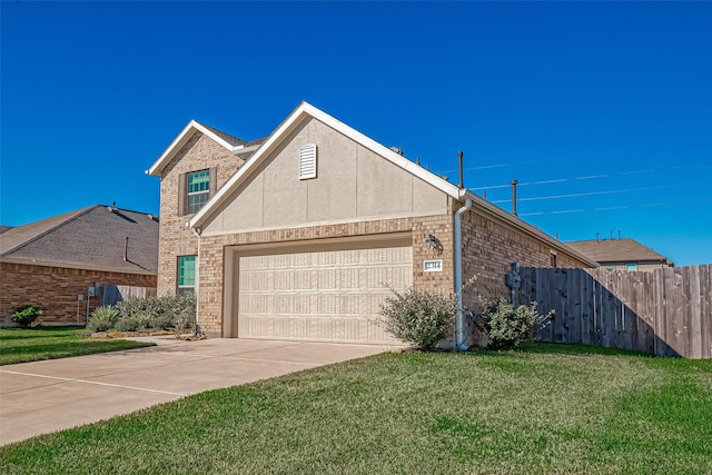 view of front facade with stucco siding, a front lawn, fence, concrete driveway, and brick siding