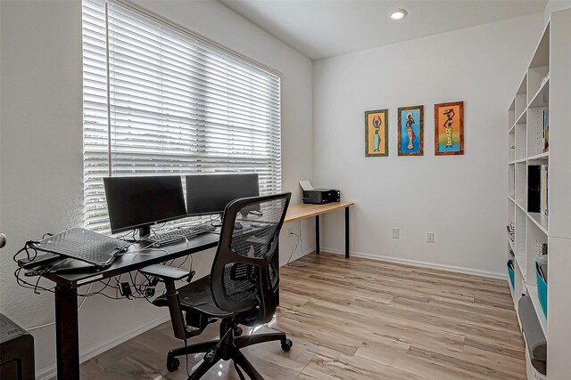 office featuring recessed lighting, baseboards, and light wood-style floors