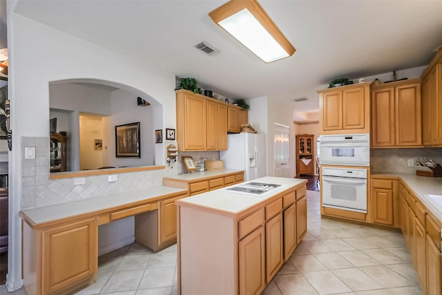 kitchen featuring visible vents, a kitchen island, white appliances, light tile patterned flooring, and light countertops