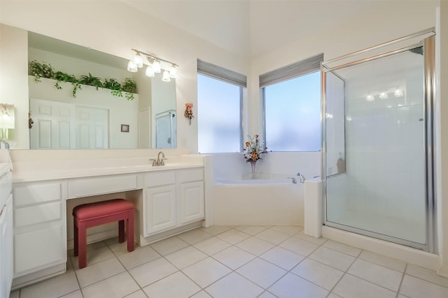 full bathroom featuring tile patterned flooring, a shower stall, a bath, and vanity