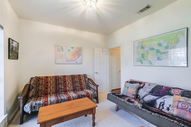 living area with visible vents and carpet flooring