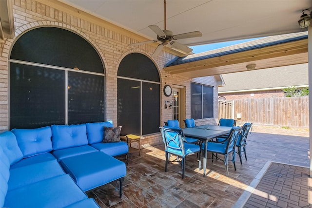 view of patio / terrace featuring outdoor lounge area, outdoor dining area, fence, and ceiling fan