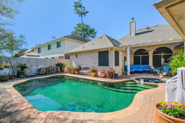 view of pool with a ceiling fan, a fenced backyard, a pool with connected hot tub, a patio area, and an outdoor hangout area